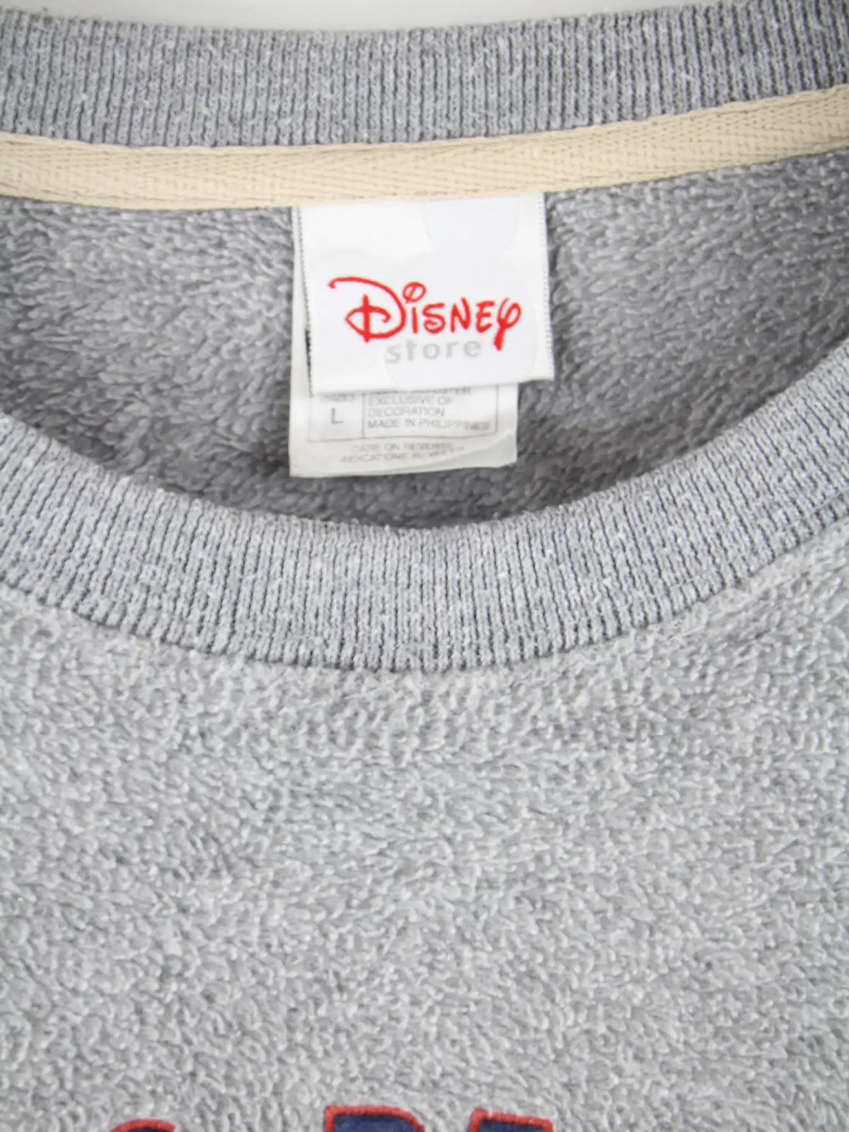 Disney Fleece Grau L – Etikett